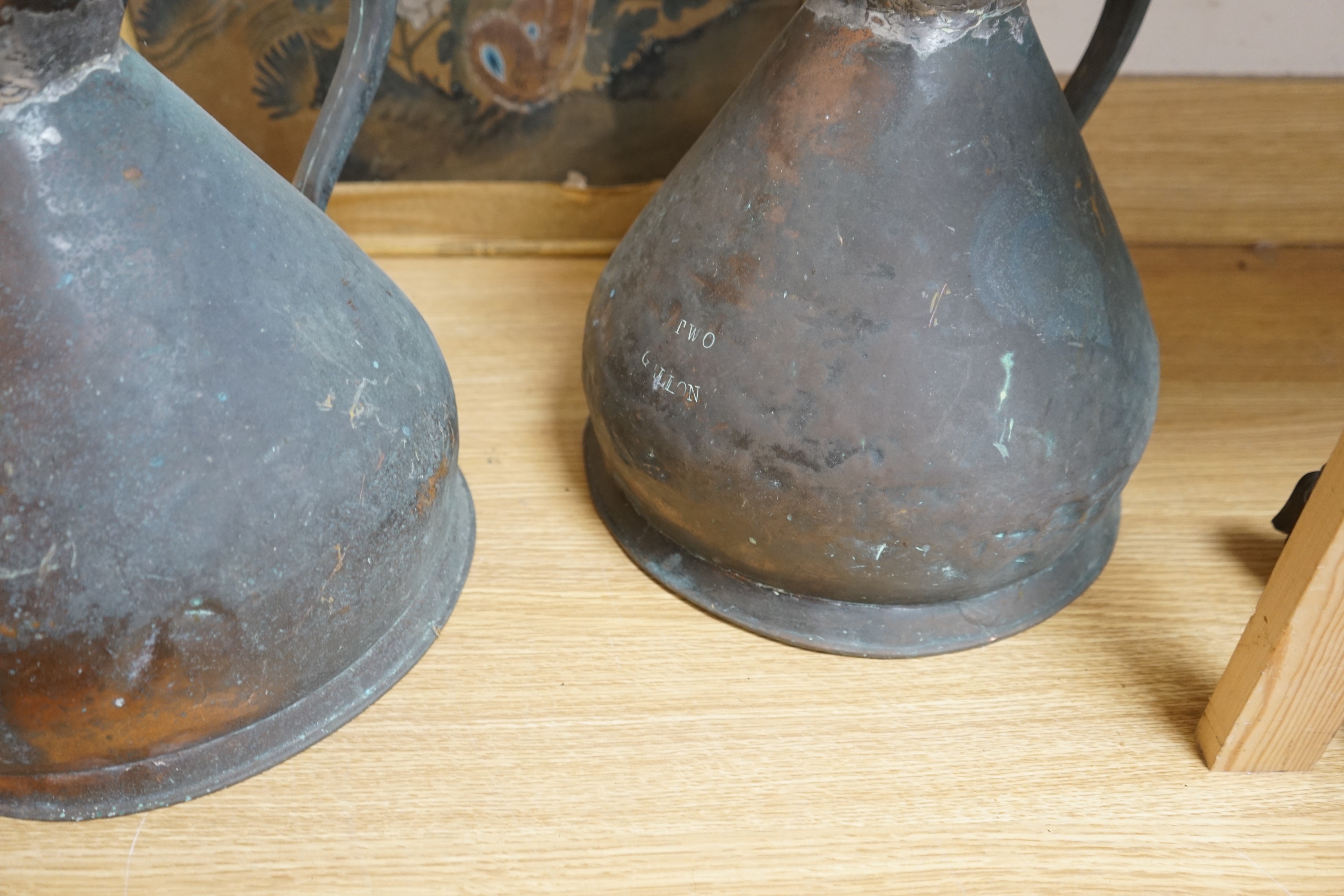 Two Victorian two gallon copper haystack measures and a wooden well bucket, Tallest 35cm